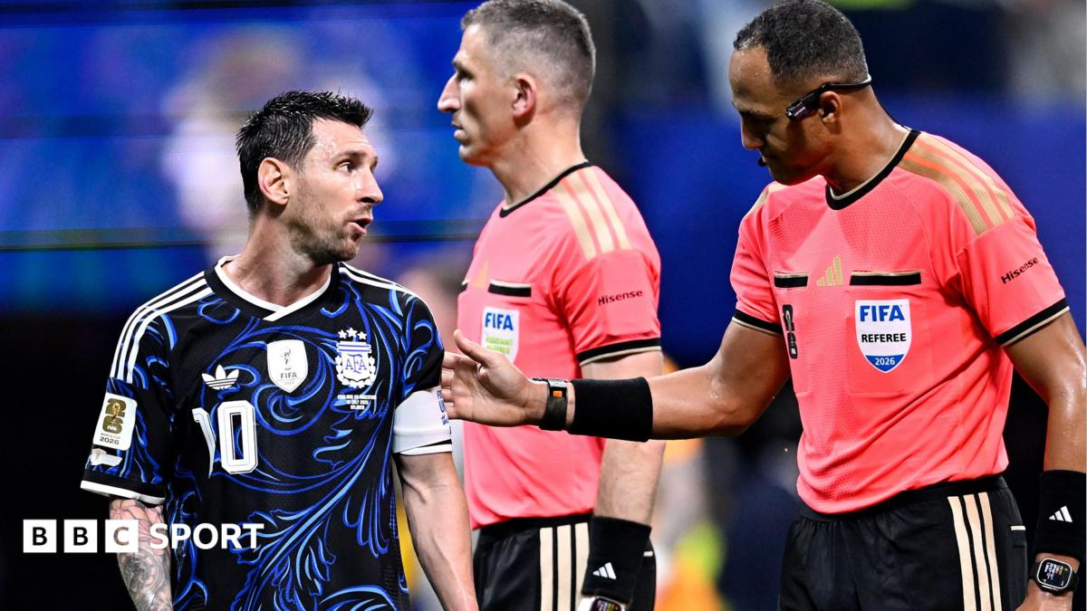 Lionel Messi in discussion with assistant referee Corey Parker and referee Ismail Elfath during Argentina's World Cup semi-final victory over England